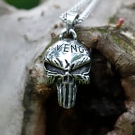 Side profile showing the dimensional sculpt and oxidized finish of the skull pendant