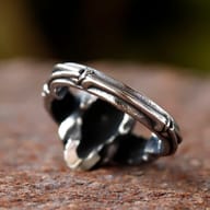 Close-up of the skull's intricate teeth and eye sockets on the durable stainless steel ring.