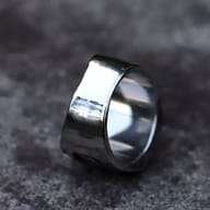 Angled view of the gothic skull ring, showcasing the square face and textured band sides.
