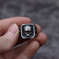 Close-up of the detailed skull motif on the face of the stainless steel ring.